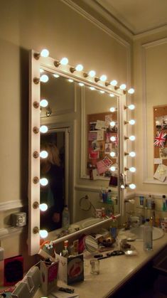 a vanity with a mirror and lights on it