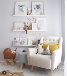 a baby's room with pictures and toys on the wall