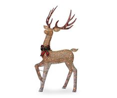 a lighted reindeer standing on top of a white surface