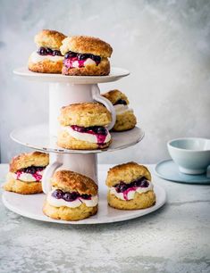 three tiered trays filled with scones covered in blueberry filling