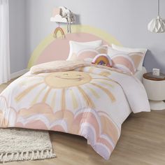 a bed in a bedroom with a pink and yellow comforter