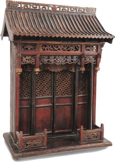 an old wooden shrine with carved designs on the front and side doors, isolated against a white background