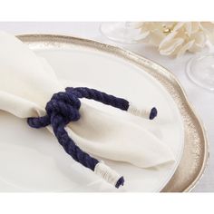 two napkins tied together on a plate