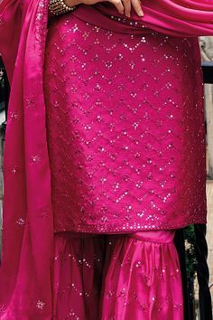 This Hot Pink Party Wear Sharara Gharara Suit flaunts sophistication with zari, resham, badla, and sequence work along the kameez. Accented by a chinnon silk embroidered sharara palazzo bottom, santoon lining, and sequence embroidered chinon silk dupatta, this ensemble is perfect for weddings and other special events. Final sale 3 piece Kameez chinon silk with heavy embroidery & khatali work Sharara chinon silk with heavy embroidery front and back Dupatta chinon silk with embroidery work Side sl Traditional Sequined Palazzo Set For Diwali, Traditional Sequined Palazzo Saree Set, Pink Dola Silk Palazzo Set For Diwali, Pink Art Silk Palazzo Set With Resham Embroidery, Pink Dola Silk Palazzo Set For Wedding, Traditional Sequined Palazzo Set For Eid, Pink Palazzo Set With Dori Work For Wedding, Sequined Semi-stitched Palazzo Set For Festivals, Festive Pink Palazzo Set With Gota Work