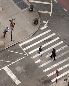 two people crossing the street at an intersection