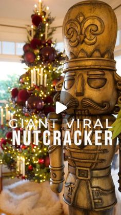 a wooden nutcracker in front of a christmas tree with the words giant virtual nutcracker