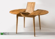 a wooden table with an open book on it's center piece and two legs