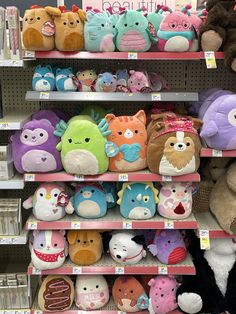 stuffed animals are on shelves in a store