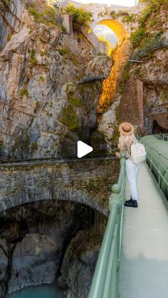 a person standing on a bridge over water