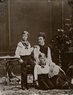 an old black and white photo of three people