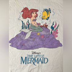 the little mermaid t - shirt is on display