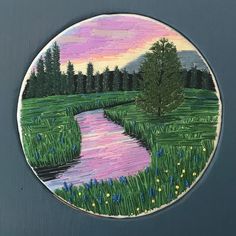 a painting on the side of a door with grass and flowers around it in front of a river