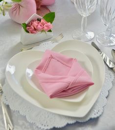 pink napkins and silverware on a white plate