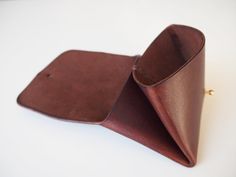 "Origami style minimal wallet made from one piece of smooth leather. Using Sam Browne as a fastener. (choose the colour from Brass and Silver) This wallet is multi purpose, you can use for many ways. - Card, note & coin purse - Credit card holder - Business card holder - Travel jewellery case.. etc Approximate Dimensions: W 4\" x H 3\" x D 0.75\" W 10cm x H 8cm x D 2cm - 100% Vegetable tanned leather - Hand stitched with waxed thread - Edges are burnished to smooth sheen - Comes with 100% co Minimal Wallet, Leather Workshop, Travel Jewelry Case, Leather Card Holder