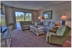 a living room filled with furniture and a flat screen tv