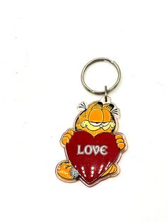 a key chain with a cartoon character holding a heart