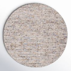 a round rug with different colors and patterns on the floor, in front of a white background