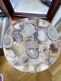 an aerial view of a table made out of agate stone, with a cell phone in the background