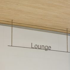 the lounge sign is hanging on the wall