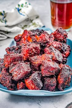 a blue plate topped with fruit covered in powdered sugar