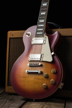 an electric guitar sitting on top of a wooden table