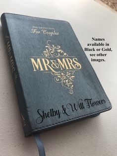 a black book with gold lettering on the front and back cover that reads, mr & mrs