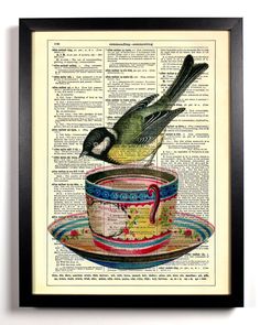 a bird sitting on top of a cup with saucer in front of an old book page