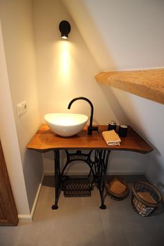 an old fashioned sewing table with a bowl sink