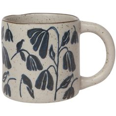 a blue and white coffee mug with flowers on it