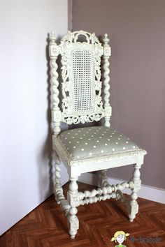 a white chair sitting on top of a hard wood floor