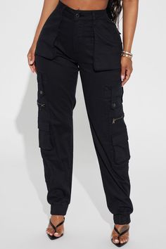 Available In Black. Jogger Fit Pant Button & Zipper Front Closure Functional Cargo Pockets Throughout 29.5" Inseam Faux Back Pockets Elasticized Ankle Jogger Hem Medium Stretch Twill 98% Cotton 2% Spandex Imported | Exotica Cargo Jogger Pant in Black size Medium by Fashion Nova Black Bottoms With Button Closure For Streetwear, Mid-rise Black Pants With Button Zip Fly, Black Mid-rise Pants With Button Zip Fly, Casual Black Bottoms With Button Zip Fly, Black High-rise Bottoms With Button Zip Fly, Black Mid-rise Pants With Button Closure, High Rise Black Pants With Button Zip Fly, Fitted High Waist Cargo Pants With Button Closure, Trendy Black Bottoms With Button Zip Fly