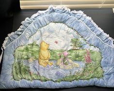 a winnie the pooh blanket is on display