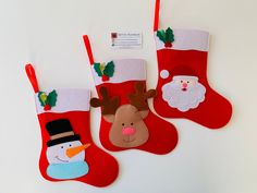 three christmas stockings with felt decorations hanging from them