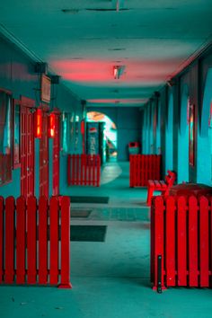 an empty hallway with red fence and blue walls