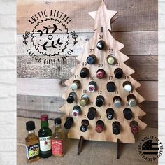 a wooden christmas tree with bottles on it