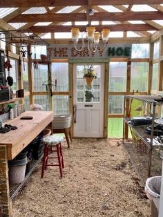 the inside of a small greenhouse with lots of plants and other things on display in it