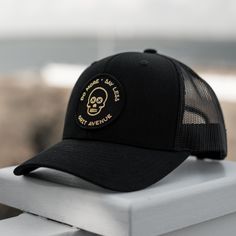 New style for 2022! • 65/35 polyester / cotton• Structured six panel• Embroidered• Mid-profile 3-1/2" crown• Curved visor• Snapback closure Black Fitted Trucker Baseball Cap, Black Trucker Hat With Curved Bill And Embroidered Patch, Black Curved Bill Hat With Custom Logo, Black Hat With Custom Logo And Curved Bill, Black Six-panel Trucker Hat With Logo Patch, Black Six-panel Trucker Hat With Embroidered Logo, Black Hat With Custom Logo For Streetwear, Black Trucker Hat With Embroidered Patch For Streetwear, Adjustable Trucker Hat With Embroidered Patch For Streetwear