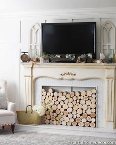 a living room with a fire place and television on top of the fireplace mantel