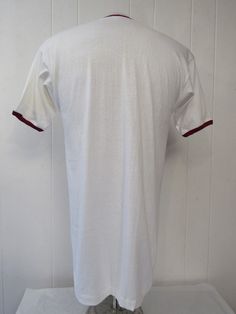 "Vintage 1950s Harvard college t shirt. Made of white cotton with Burgundy trim. Harvard with the Harvard crest. Has old goal runner label. Size large. Actual measurements are: 38\" around the chest 38\" around the waist 19\" shoulder to shoulder 32\" overall length In excellent unused condition, new old stock. it does have a faint dust line from storage near the crest, it will clean, but I wanted to leave original." Harvard College, College T Shirts, Vintage 1950s, Vintage Tshirts, Vintage Clothing, White Cotton, Vintage Outfits, Overalls, Trim