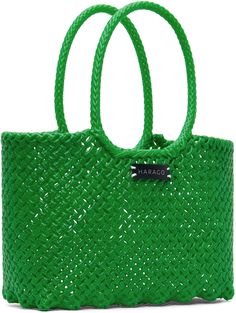 Structured hand-woven upcycled plastic tote in green. · Twin carry handles · Logo patch at face · Open throat · H9 x W16.5 x D5.5 · Total height: 14.5 Supplier color: Green Green Recyclable Shopping Bag, Large Green Casual Bag, Green Recyclable Bags, Green Rectangular Bag With Reinforced Handles, Green Rectangular Bags With Reinforced Handles, Green Recyclable Summer Bag, Green Recyclable Bag For Summer, Recyclable Green Vacation Bag, Summer Green Recyclable Bag