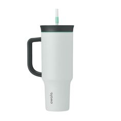 a white travel mug with a black handle