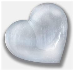 a white heart shaped object sitting on top of a table