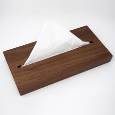 a napkin holder made out of wood with a tissue paper dispenser on top