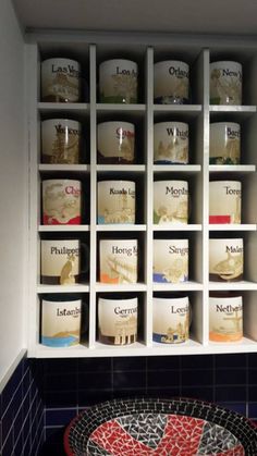 the shelves in this bathroom are filled with candles and containers that spell out their names