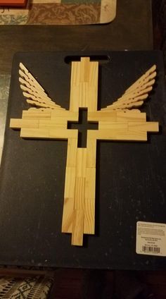 a cross made out of wood sitting on top of a table