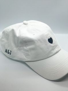 White or black, adjustable baseball cap perfect for an engagement gift, a bridal shower, or bachelorette party. Customizable first name initials on the side of the cap. Use promo code SAVEHATS to save 10% on 5 or more hats! Please note- all custom hats require at MOST 14 days to process, as each hat is made to order. This does not include shipping time. Based on the volume of orders at the time, this processing time may be shortened! If you are working on a timeline, be sure to message me so we Wedding Baseball Hat, Bach Gifts, Bach Gift, Cap Code, White Baseball Hat, Custom Baseball Hats, Bachelorette Hats, White Baseball Cap, Bf Gifts