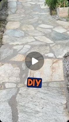 a stone path with a sign that says diy on it and an arrow pointing to the right