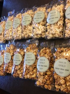 several bags of popcorn sitting on top of a table next to each other with labels