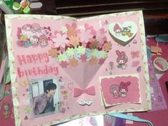 a pink birthday card with pictures and flowers on it