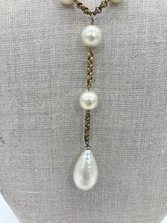 Vintage Chanel Pearl Lariat Necklace in very good condition. 1/2" pearl beads strung through a gold tone chain in a unique Y lariat style. 4.5" straight chain drop at center of Y with 1.25x.75" Teardrop pearl at end. Overall very good vintage condition. pearls are clean with no major scuffs or damage. Light tarnish on metal chain throughout. See photos for details. 39" total length end to end. Creator: Chanel Stone: Pearl Stone Cut: Bead Period: 1980-1989 Date of Manufacture: 1980s Condition: Good